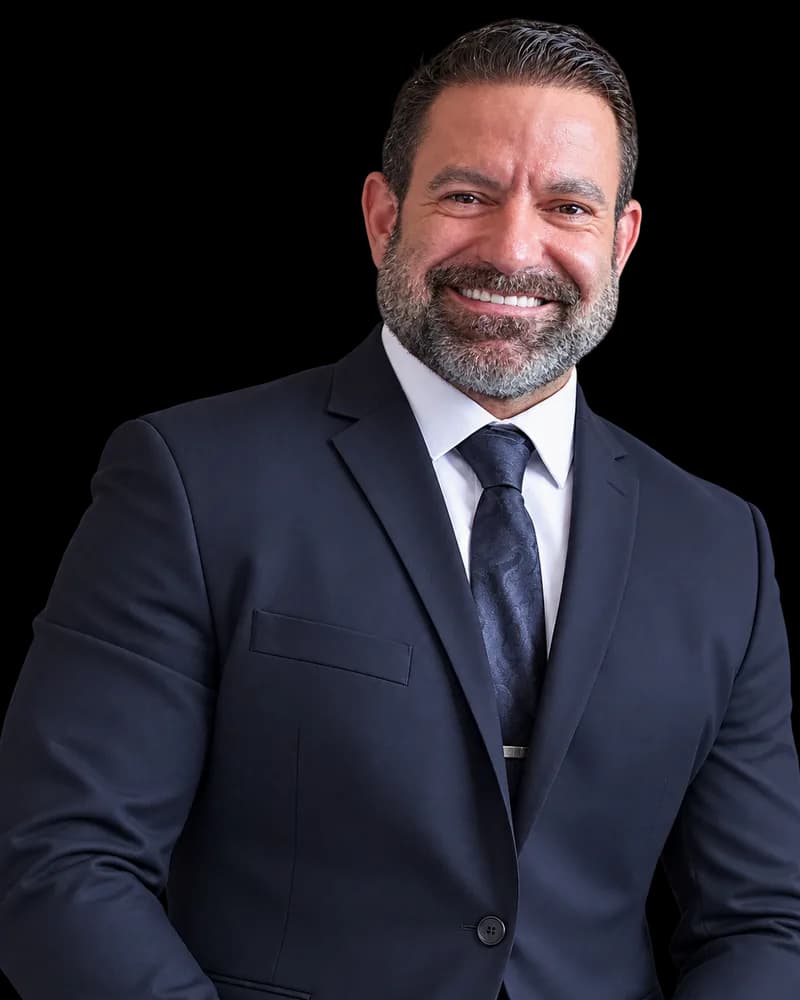 Aron Richotti in a navy suit